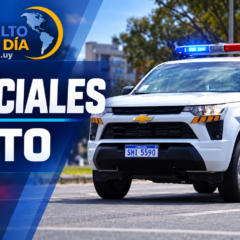 Efectivo policial trasladando a un detenido en Salto.